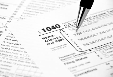 A pen over a US Form 1040 individual income tax return